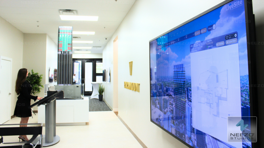 Interactive real estate sales platform LiveSite® used on a touchscreen in a sales gallery, integrated with a physical scale model