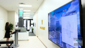 Interactive real estate sales platform LiveSite® used on a touchscreen in a sales gallery, integrated with a physical scale model