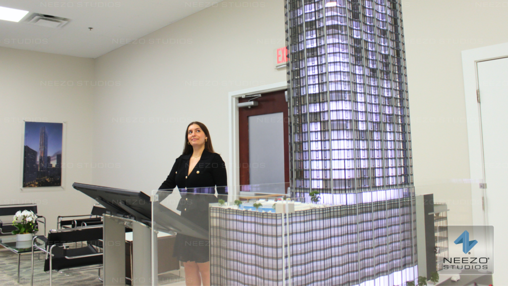 Interactive real estate sales platform LiveSite® used on a touchscreen in a sales gallery, integrated with a physical scale model by NEEZO Studios